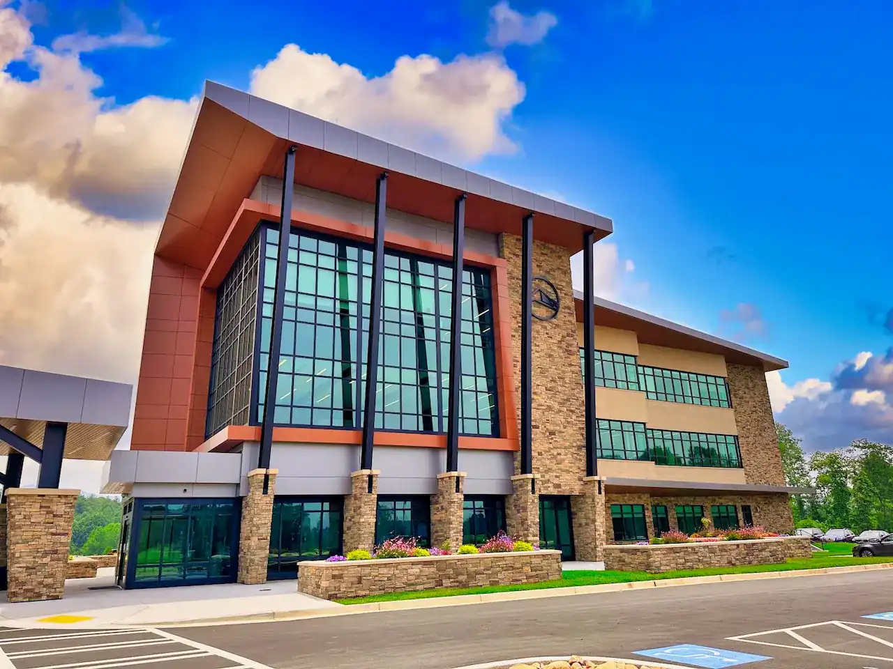 Three-story stone and glass office building with landscaped entry